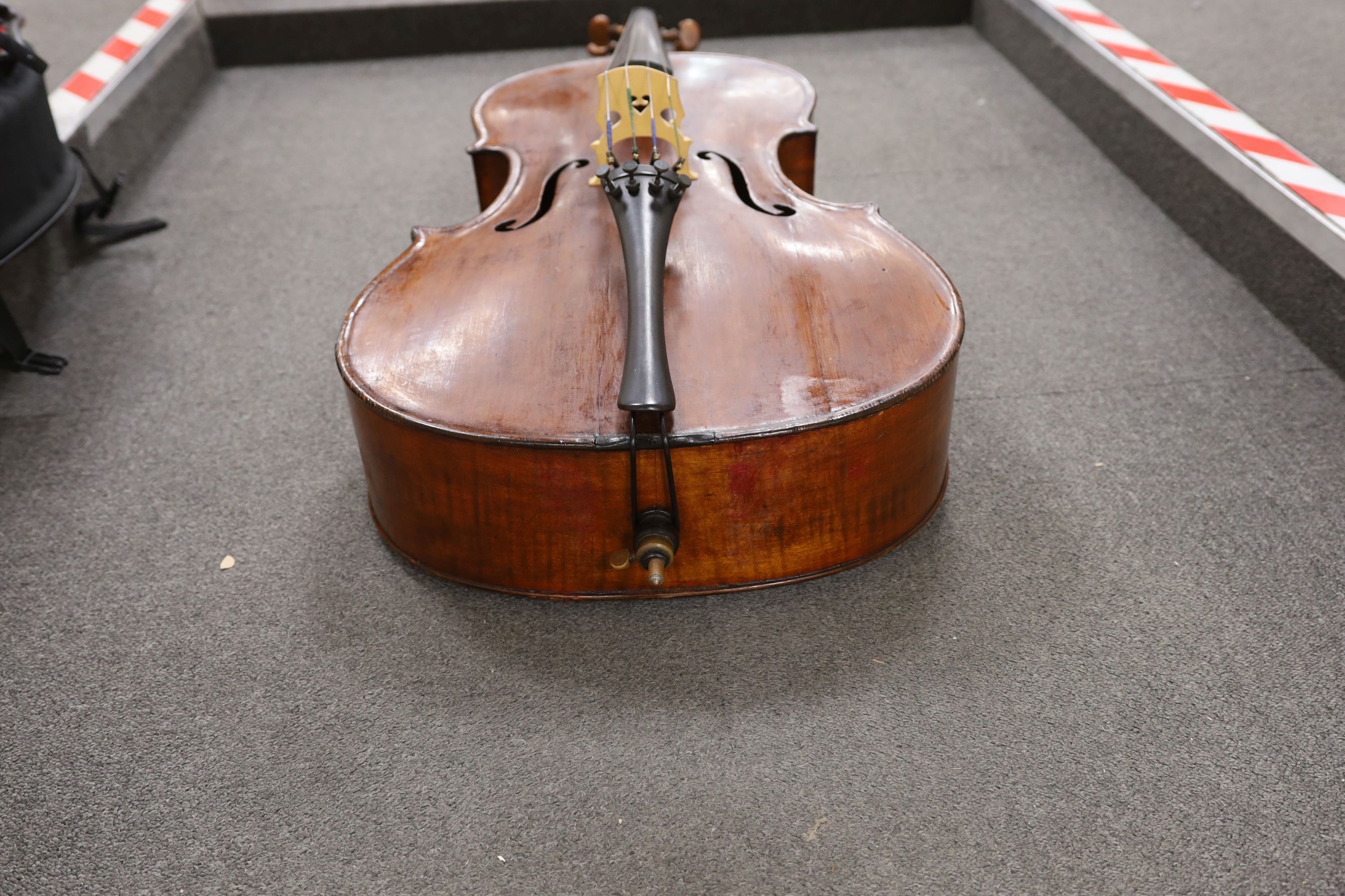 A cased early 20th century ‘cello, length of body 75.5cm, with two spare bridges, and spare strings